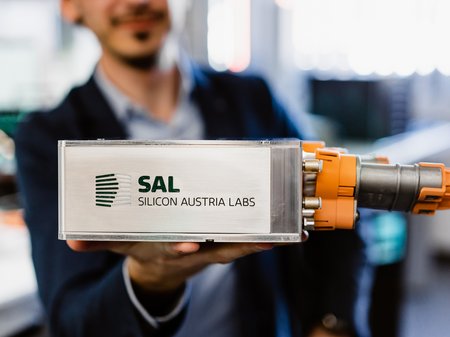 researcher holds Tiny Power Box into the camera