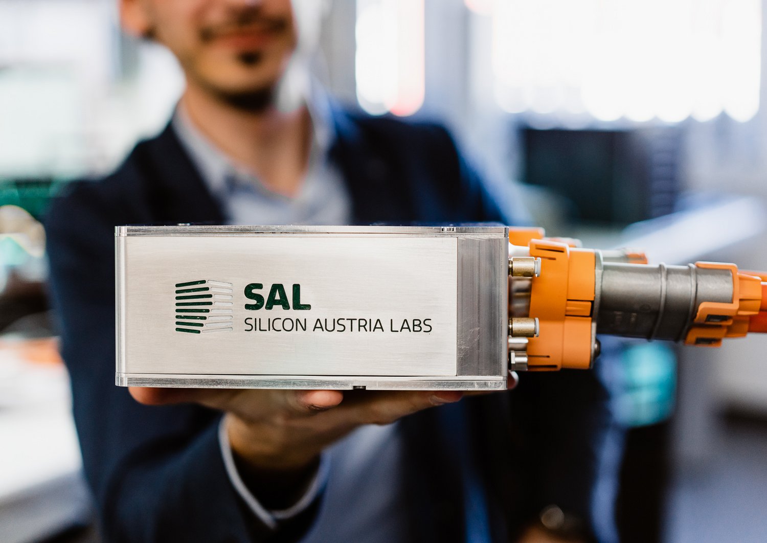 researcher holds Tiny Power Box into the camera