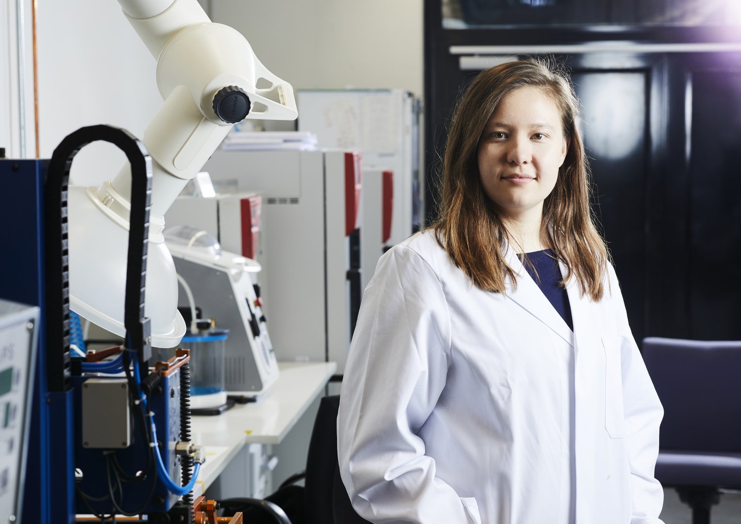 Tutku in a white lab coat in the lab