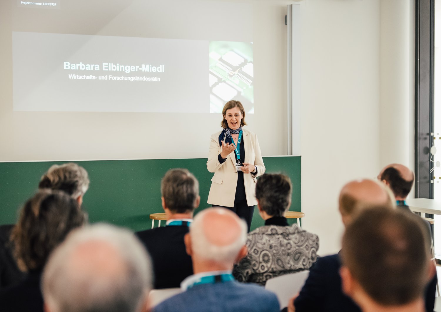 Barbara Eibinger-Miedl gives a presentation to a group of people