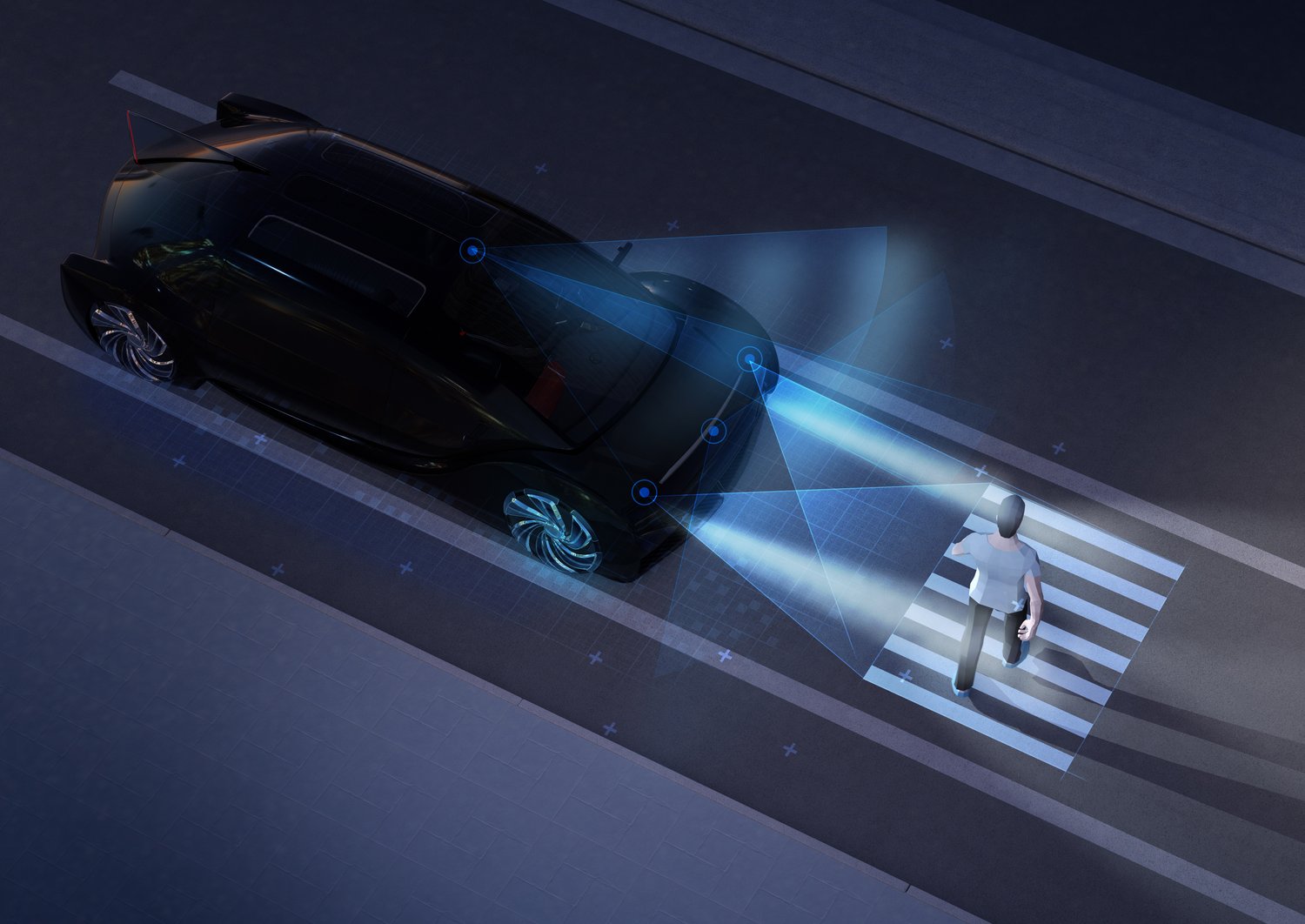 car stopping at a crosswalk at night to let a pedestrian pass