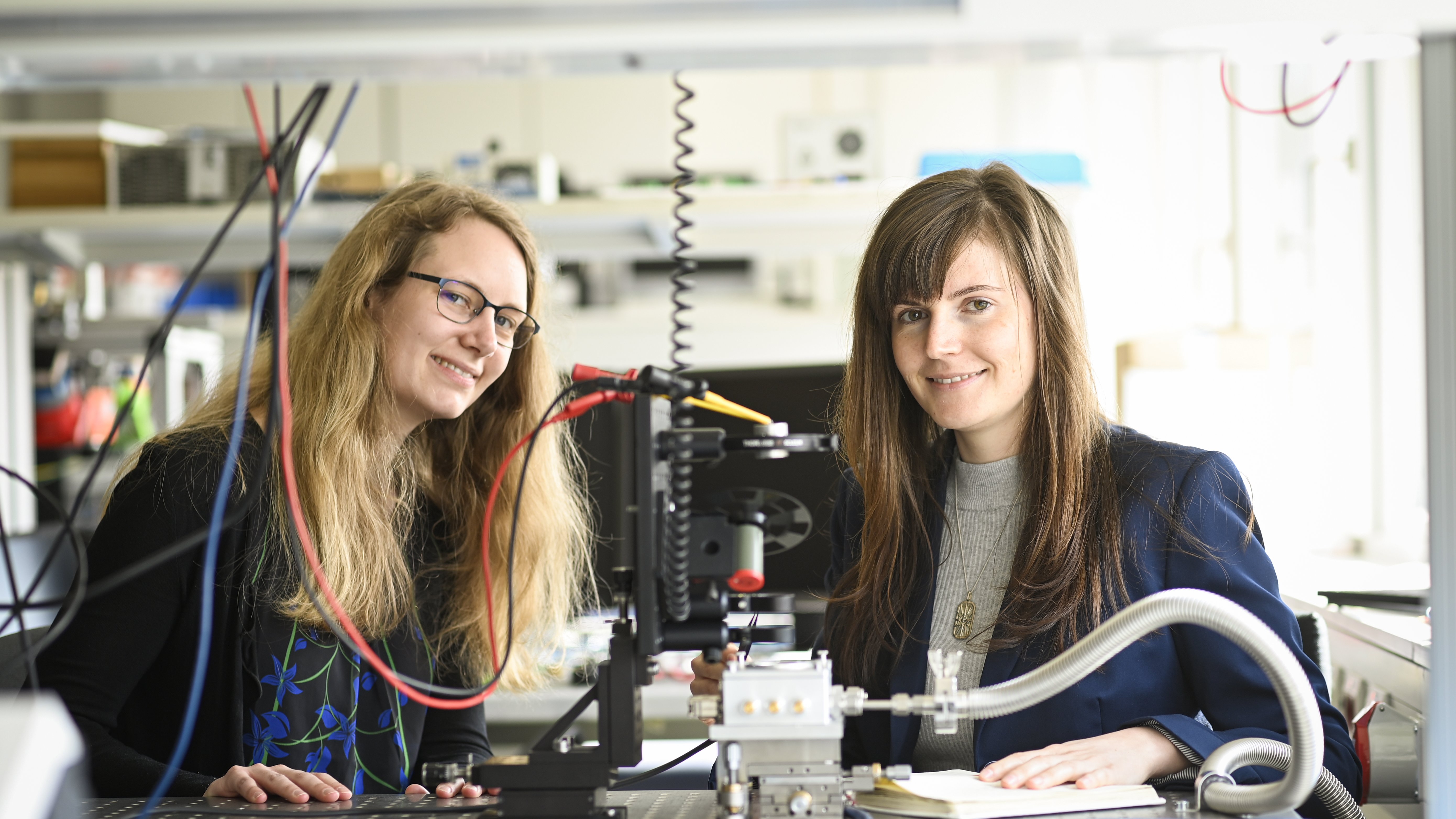 two researchers in a lab, laughing