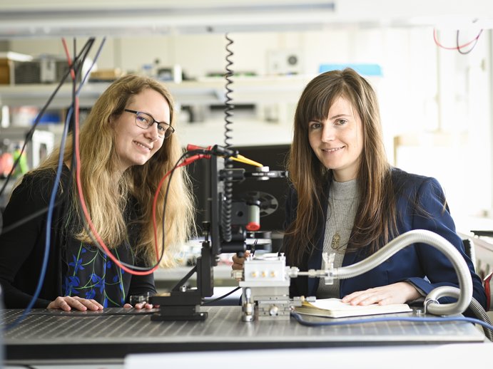 researchers at a measuring set-up in a lab