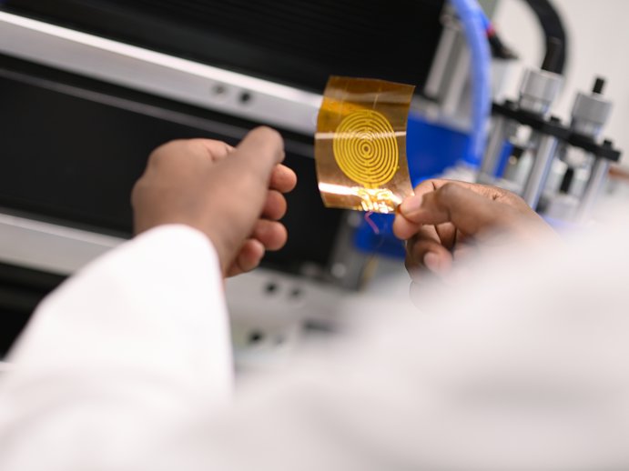 close-up of researcher holding a printed sensor