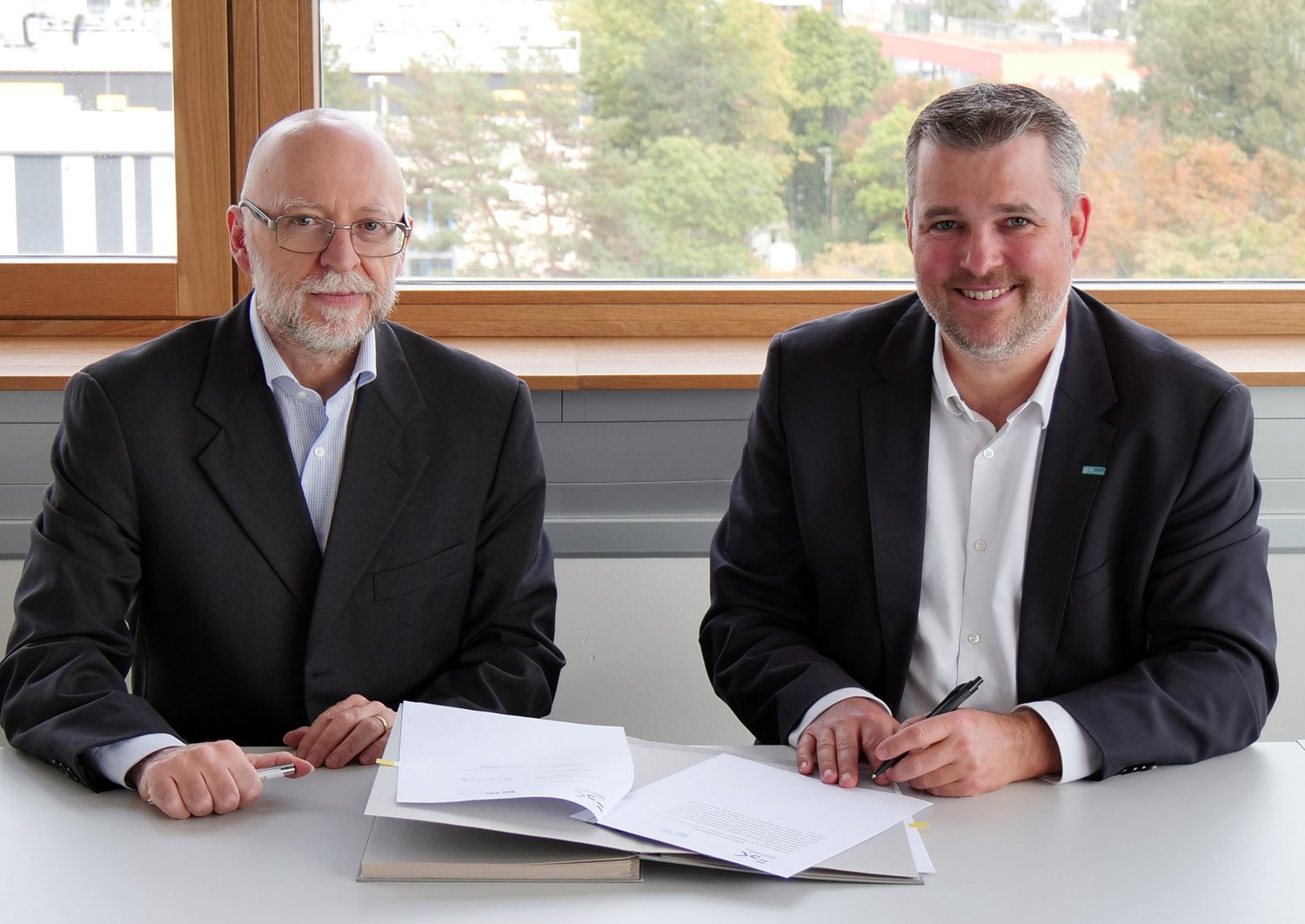 Alessandro Cimatti und Gerald Murauer lächeln in die Kamera 